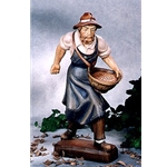 Woodcarving farmer sowing